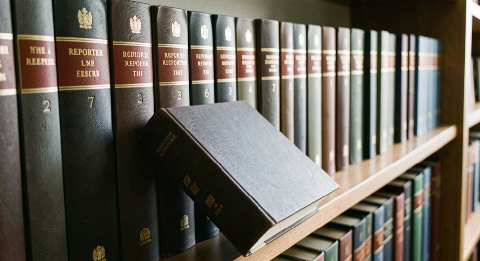 Illustrative image: a shelf of numbered reporter volumes with gilt spine labels, one volume pulled forward from the row